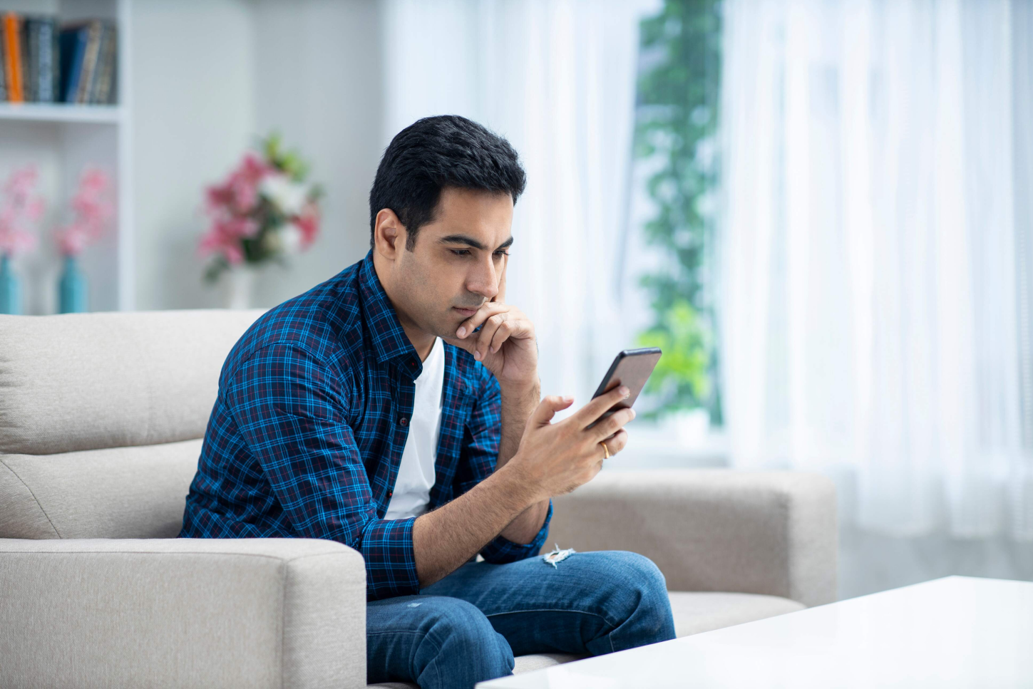 Young man at home sofa sitting - Hero Image